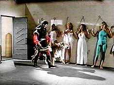 Oh, man, not another "Showgirls/Commandos chained to a Sheiks wall, menaced by a tiger" scene! Like thats not in every other movie!