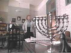 Meanwhile, the Menorah subtly placed in this shot indicates that these are good people.