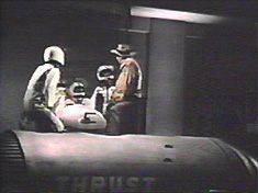 Our heroes discuss how they can possibly all fit inside the teeny-weeny Bore unit.