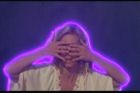 Ms. Newton-John helpfully demonstrates the best method for watching Xanadu.